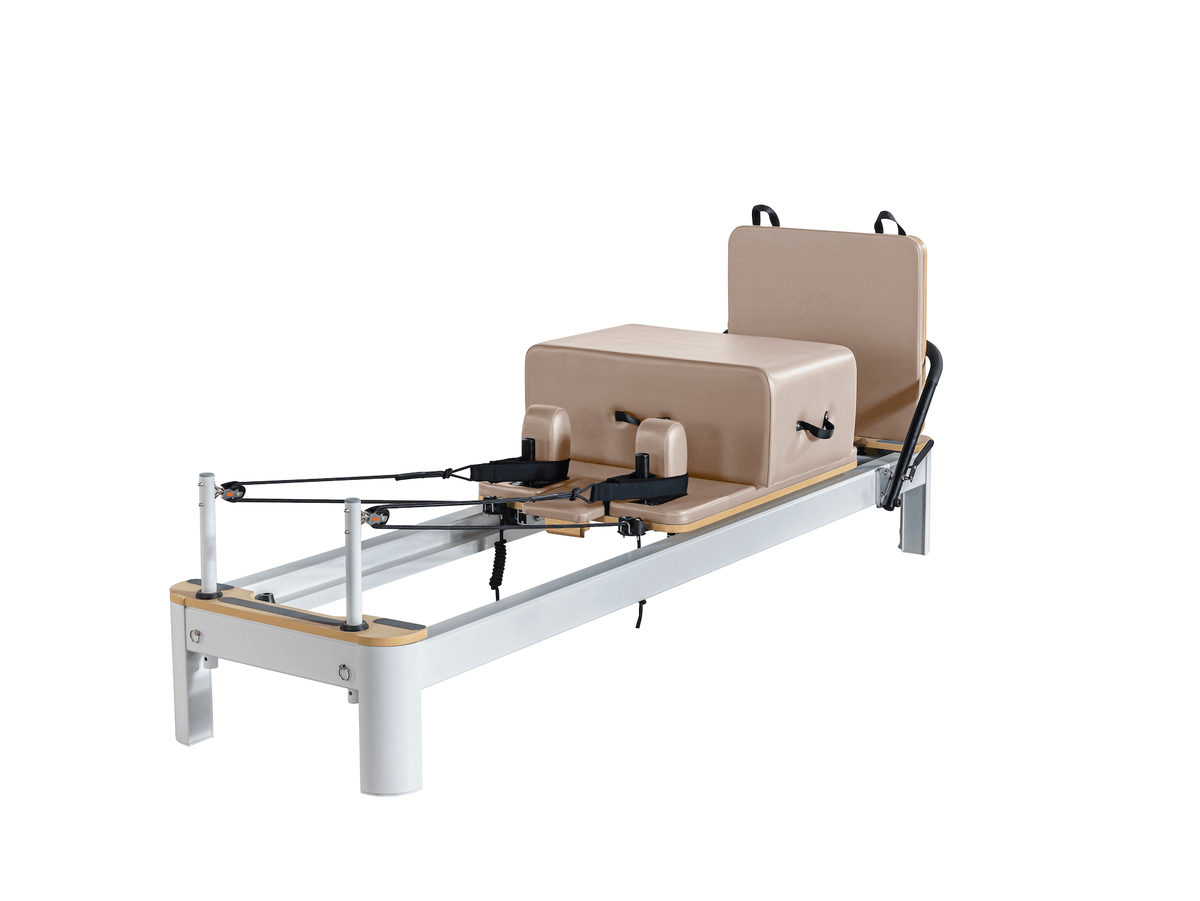Silver frame customized Pilates reformer with dusty rose beige upholstery on carriage, box, and platform