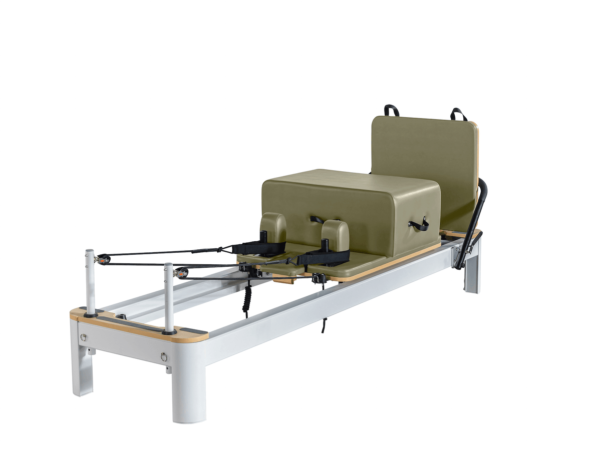 Olive green upholstered Pilates reformer with silver aluminum frame displayed on clean white background