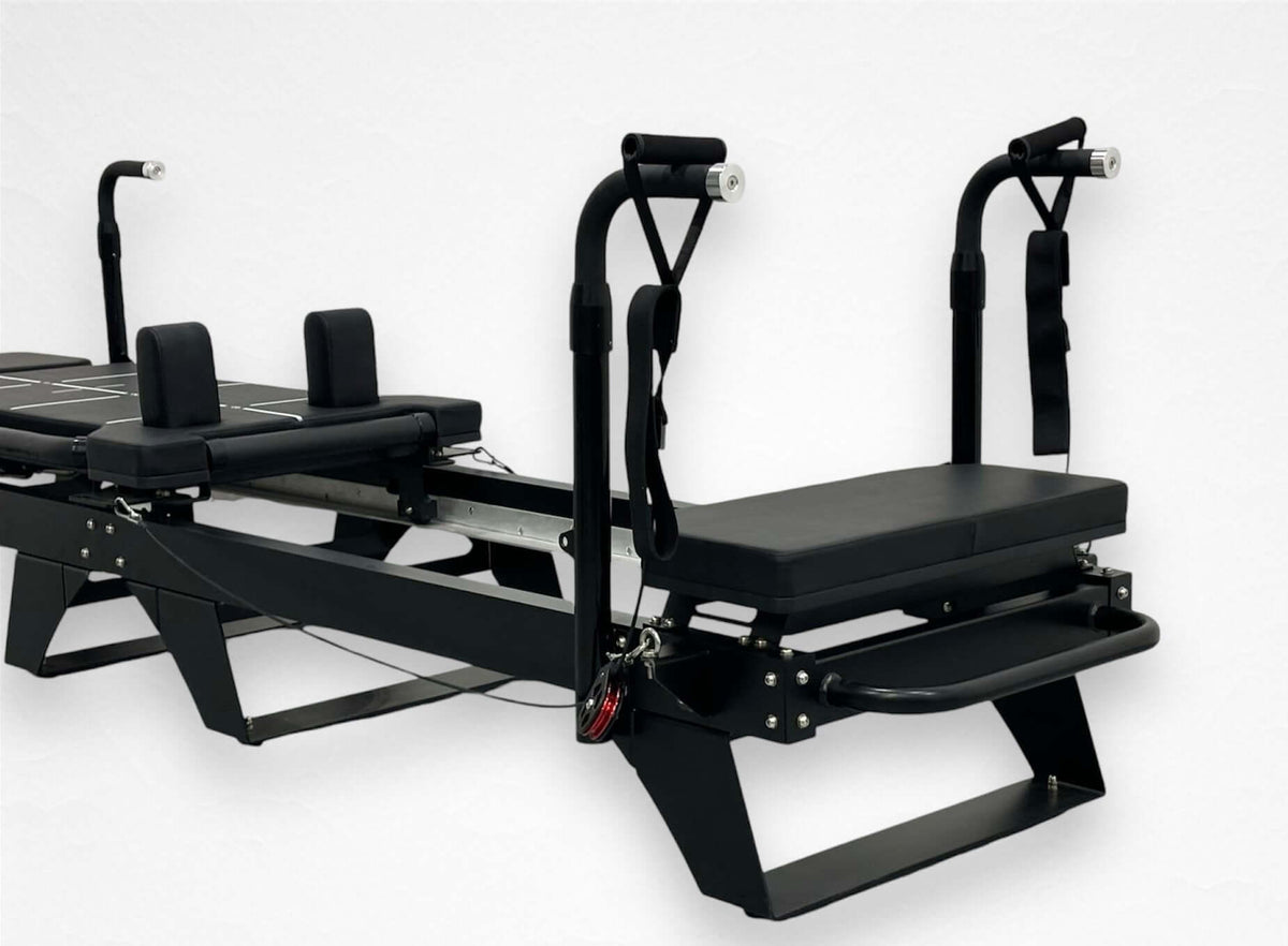 Black Sculptformer machine side view featuring sliding carriage with foam rollers, vertical handles, and steel base