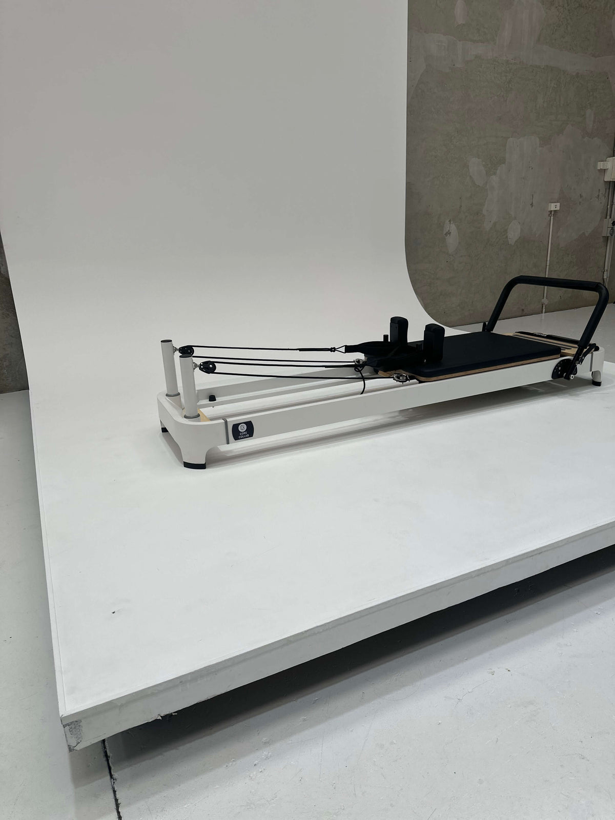 High-angle shot of black reformer showing carriage length and pulley alignment