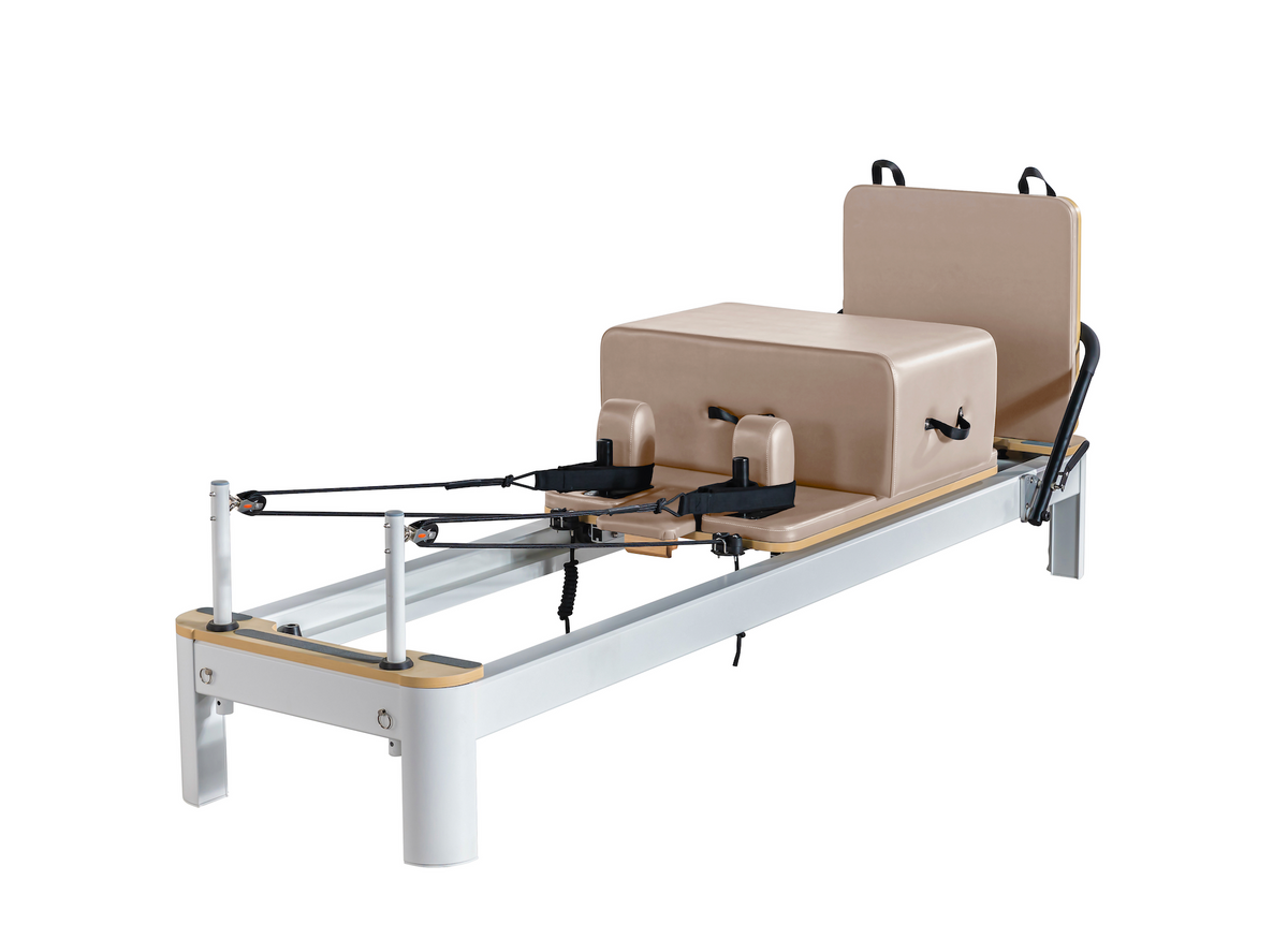 Silver aluminum Queen Pilates Reformer with natural wood trim and tan padding