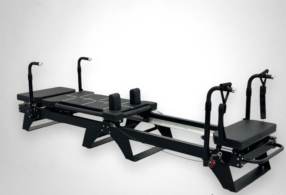 Side profile of black Sculptformer fitness machine highlighting heavy-duty metal frame, dual rails, and cable attachments
